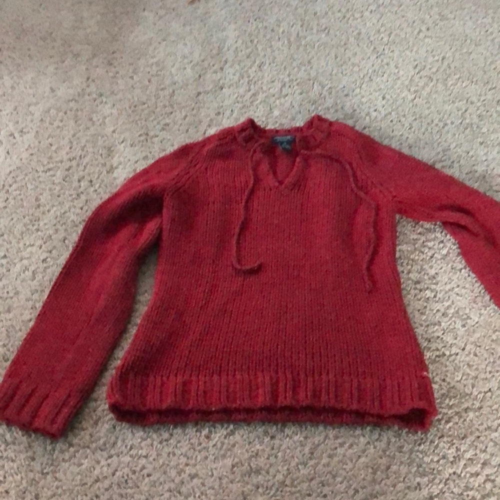 red sweater with ties at top